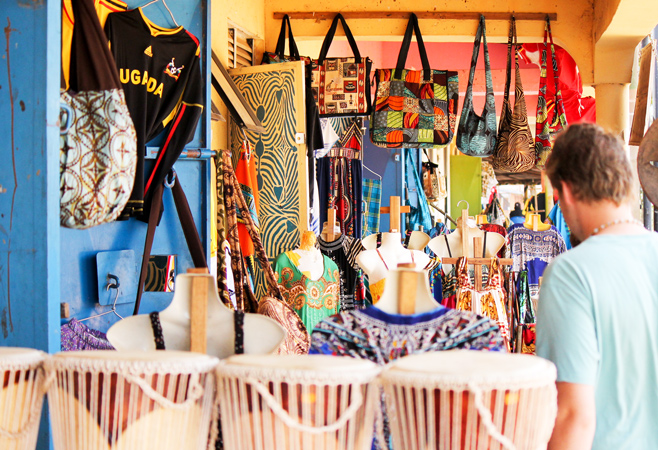 Tourists exploring craft stalls at Pearl Crafts Village Uganda