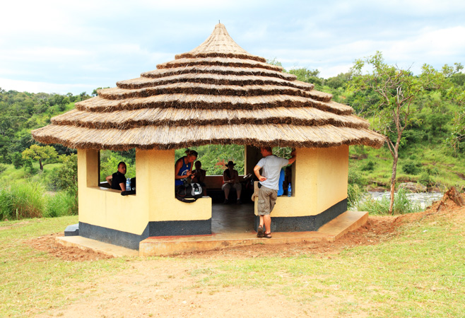 Visitors exploring Kasubi Tombs in Kampala Uganda