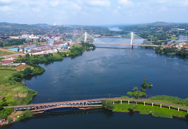 A cityscape under a partly cloudy sky in Jinja, Uganda
