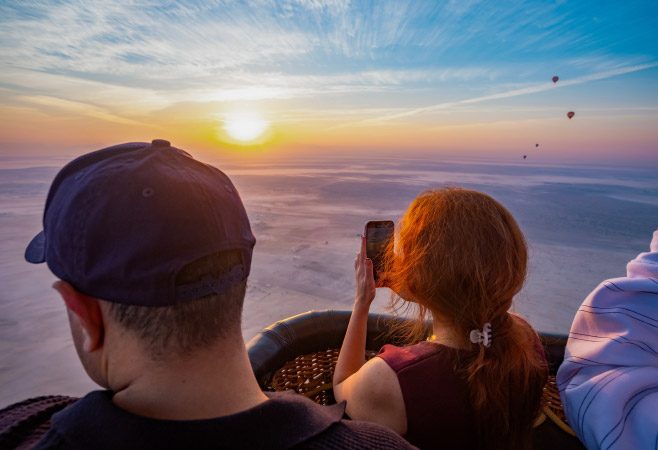 A family who are tourists taking a selfie from the hot air balloon ride in Uganda A family who are tourists taking a selfie from the hot air balloon ride in Uganda