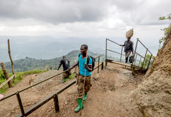 Guides and porters assist tourists climbing Mount Elgon, a tourist attraction for hikers, climbers and bird watchers visiting East Africa.
