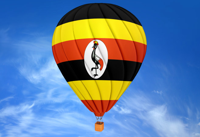 Hot air balloon with Uganda Flag in blue sky with cloud Hot air balloon with Uganda Flag in blue sky with cloud