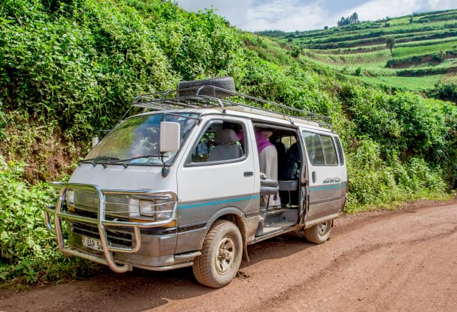 Minivan on a rural dirt road in southwestern Uganda, at the Bwindi Impenetrable Forest National Park, at the borders of Uganda, Congo, and Rwanda