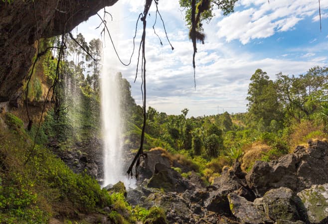 A panoramic view of Sipi Falls cascading down the lush cliffs of Mount Elgon