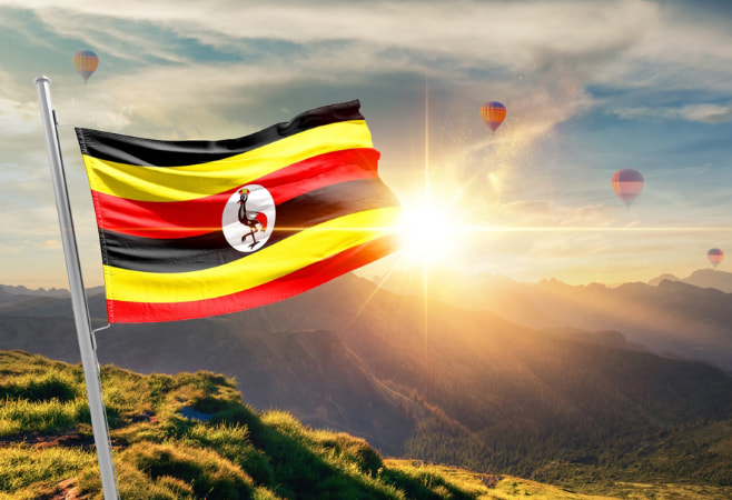Flag of Uganda with passport and airplane
